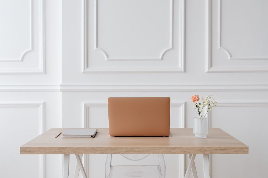 A calm, tidy home study space with a clear desk, good natural light, a notebook and books, and no phone or screen in view.